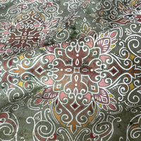 Thumbnail for Close-up of patterned fabric with intricate designs on a green background