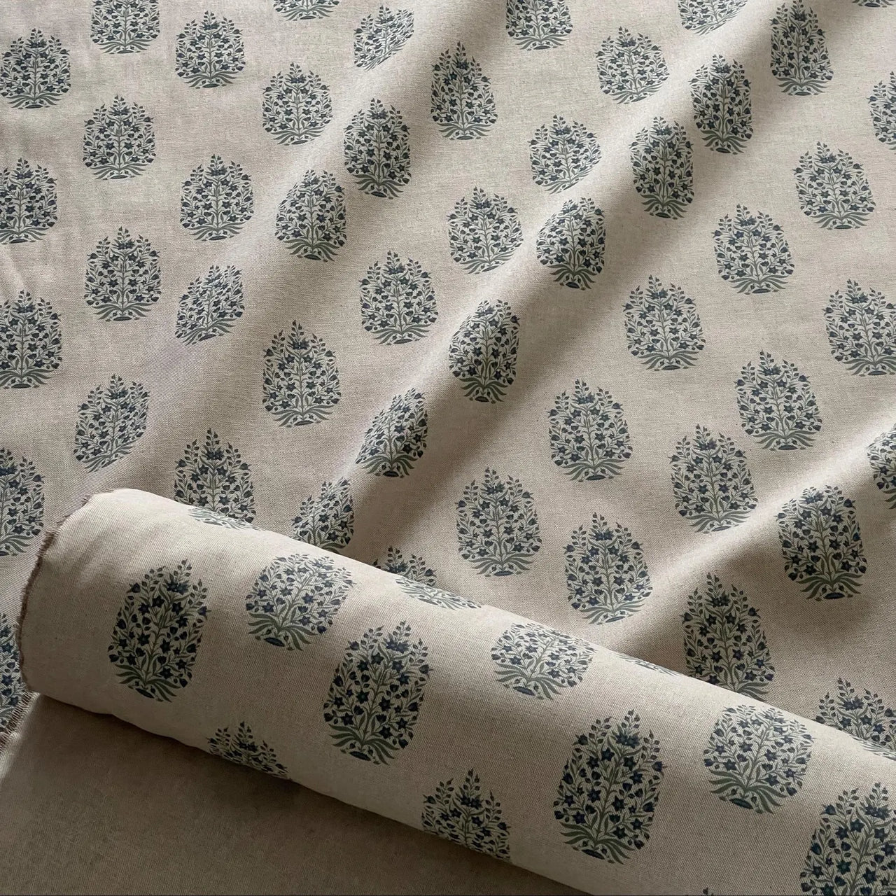 Neutral linen fabric with subtle blue floral sprig medallion pattern