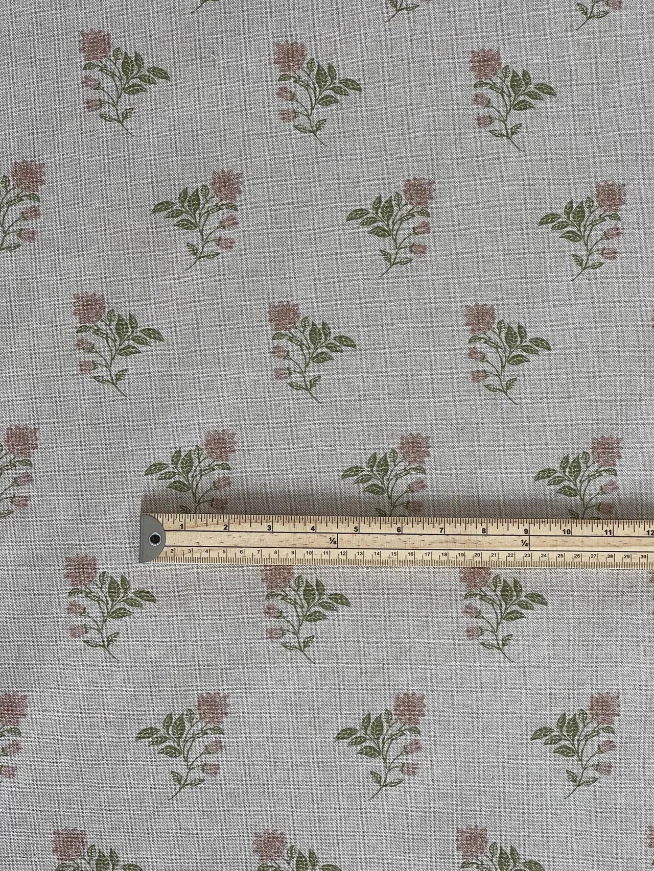 Floral patterned fabric with a ruler for scale on a gray background