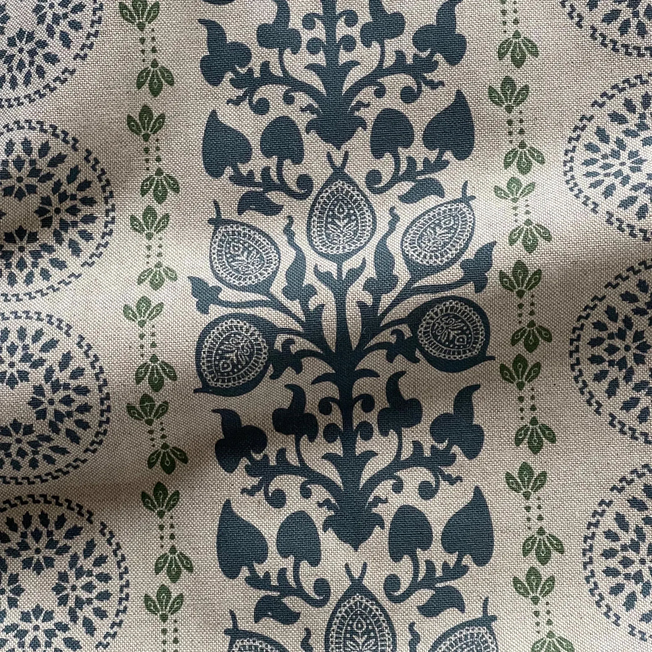 Soft furnishing fabric with navy botanical medallion repeat pattern