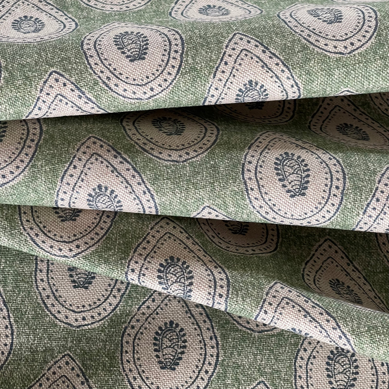 Green cotton blend fabric with Indian inspired paisley design
