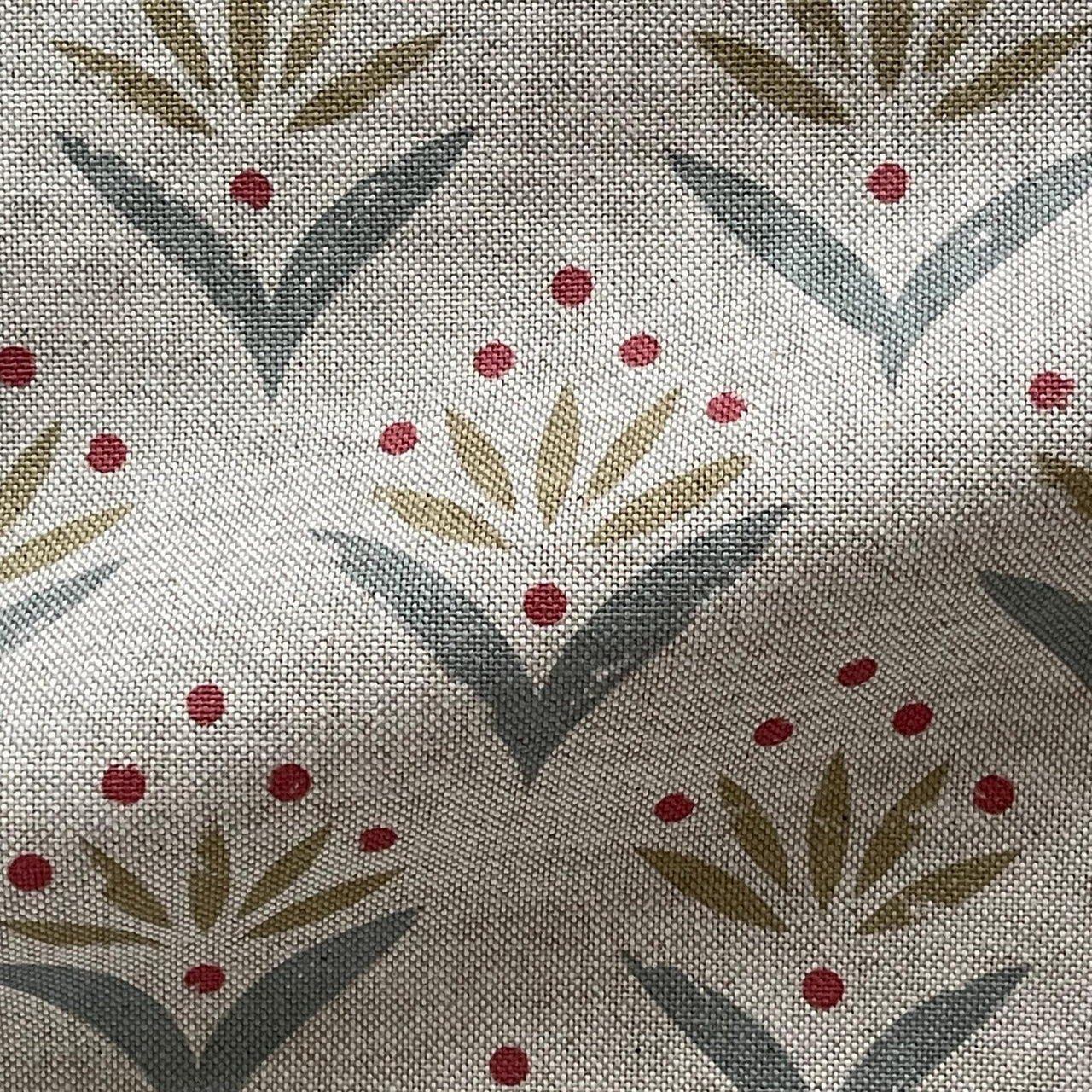 Textile pattern with abstract leaves and red dots on a neutral background