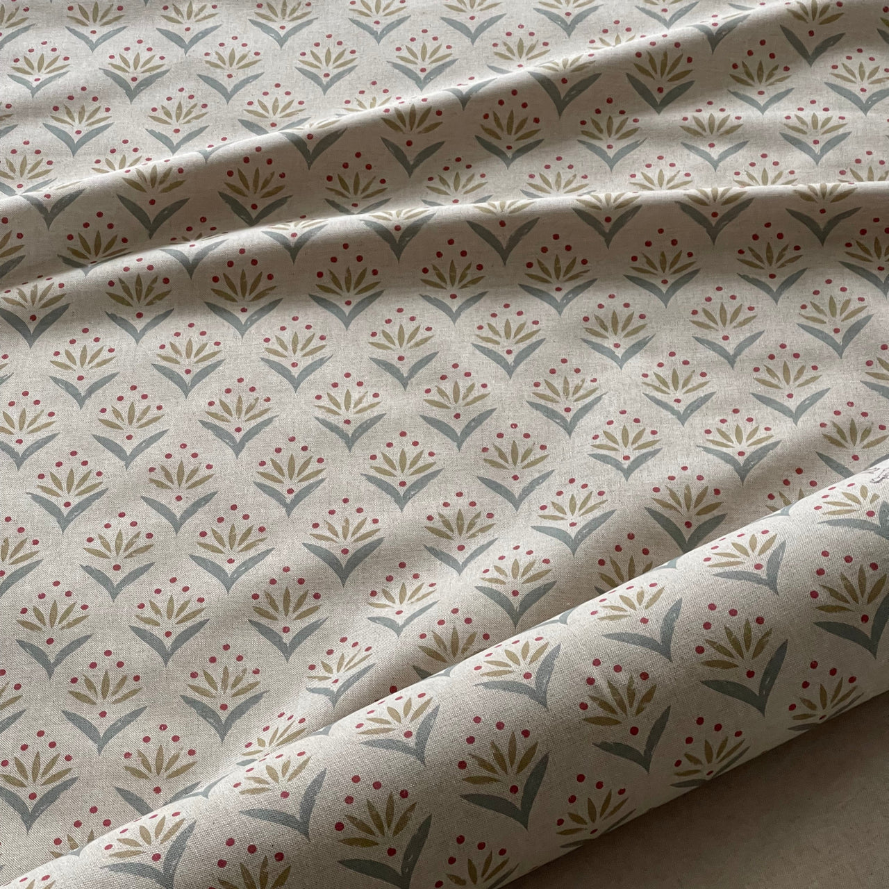 Duckegg country floral fabric close up showing botanical leaf and berry design.