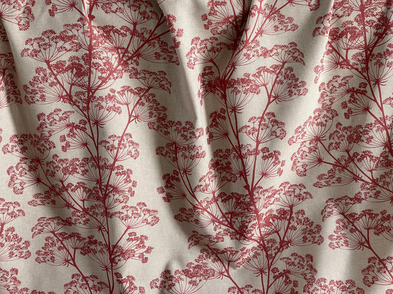 Decorative floral fabric in red tones for upholstery and sewing