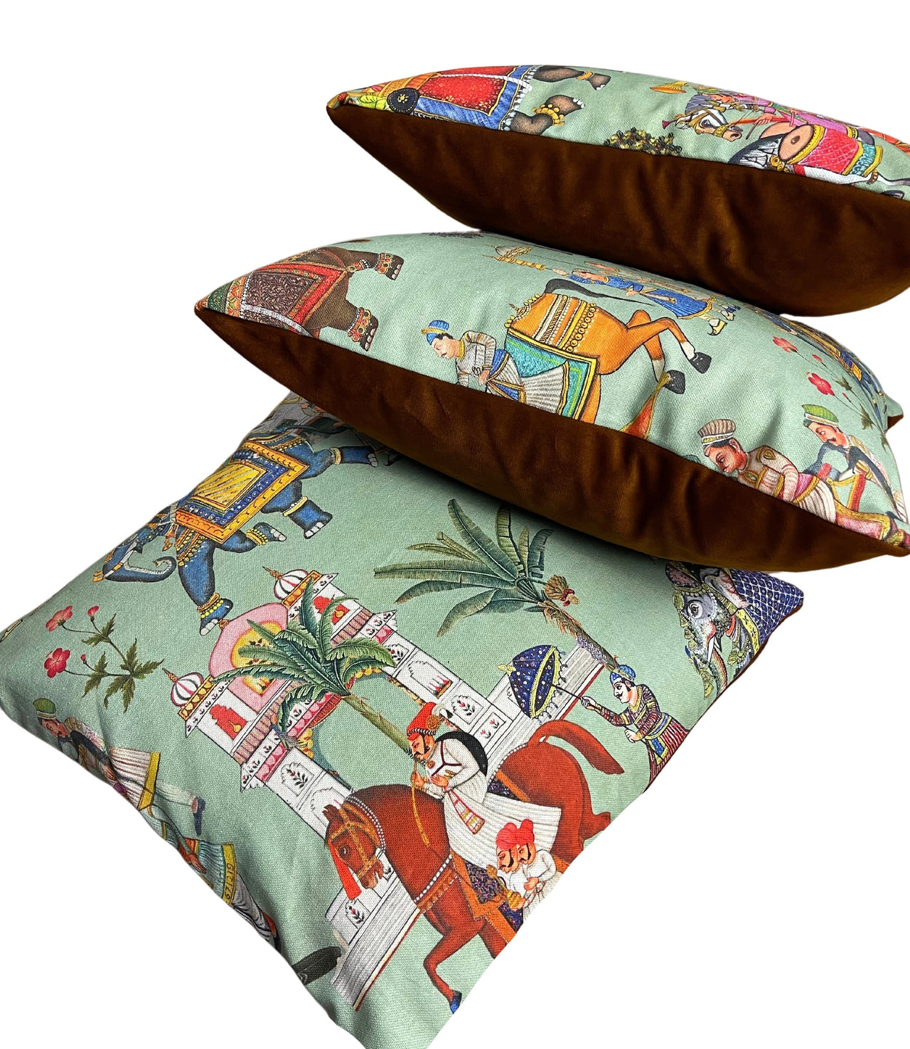 Three decorative pillows with intricate patterns on a white background