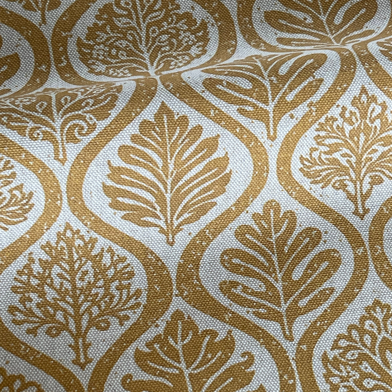 Ogee pattern fabric with botanical leaves in mustard tones