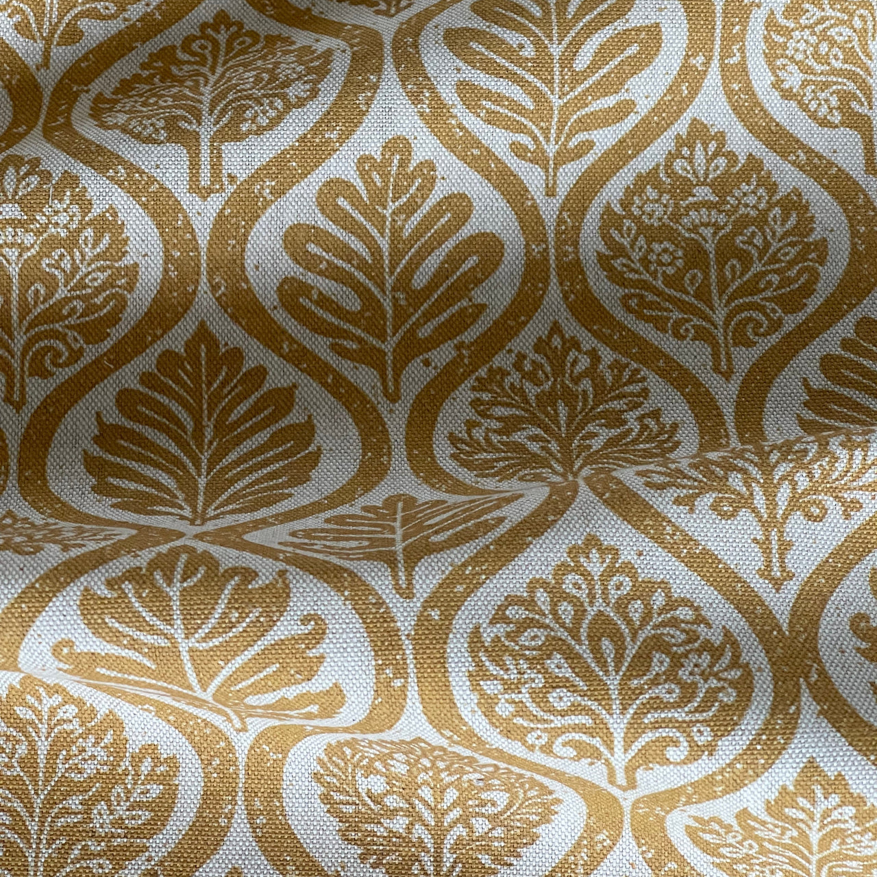 Scandinavian style mustard fabric with curved ogee pattern
