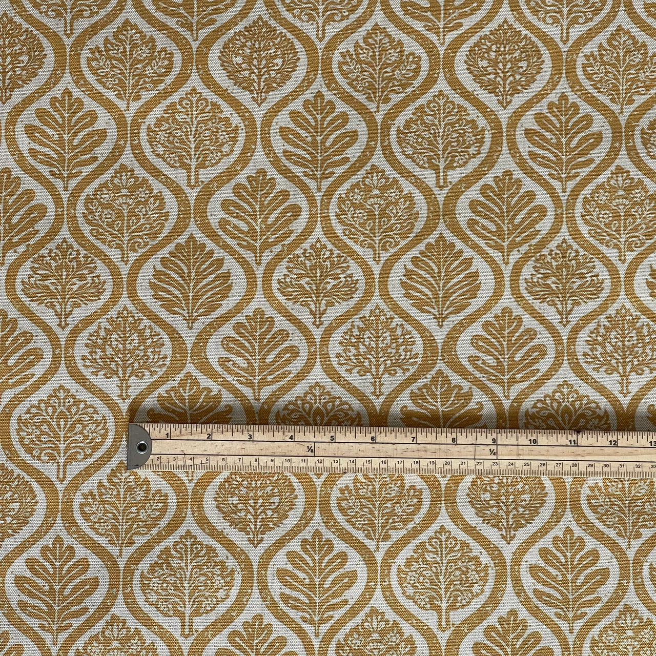 Botanical ogee upholstery fabric in mustard and natural tones