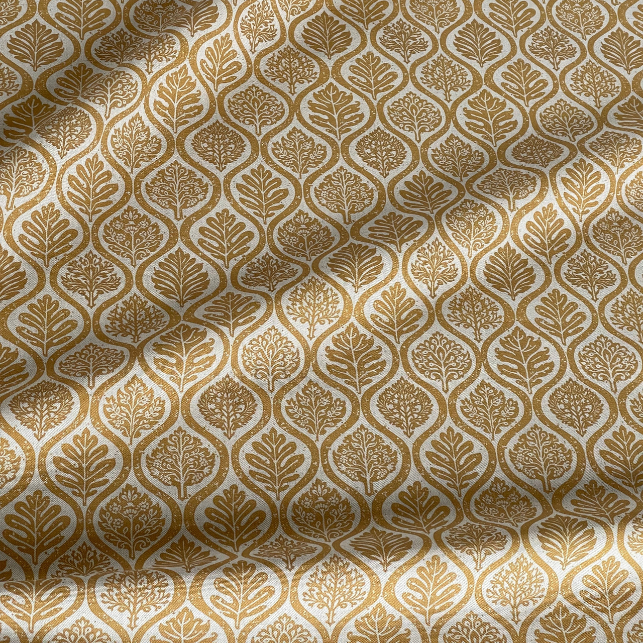 Ochre ogee fabric with repeating leaf design on neutral base