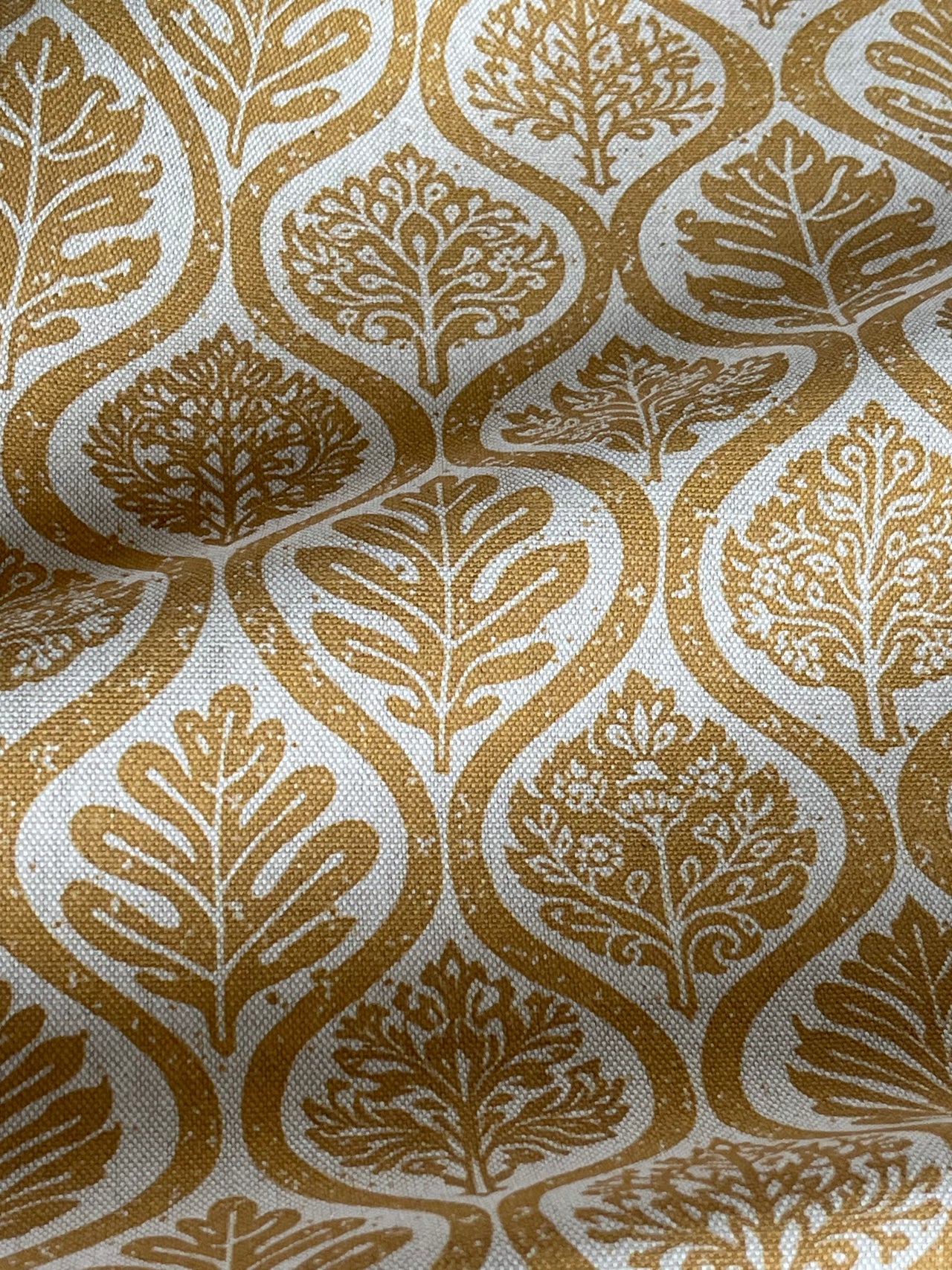 Linen look mustard fabric with decorative leaf motif