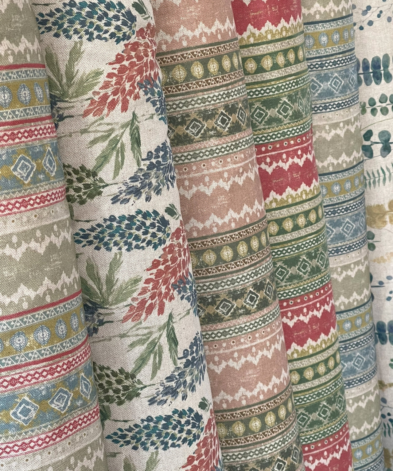 rolls of fabric with various patterned country style linen print 