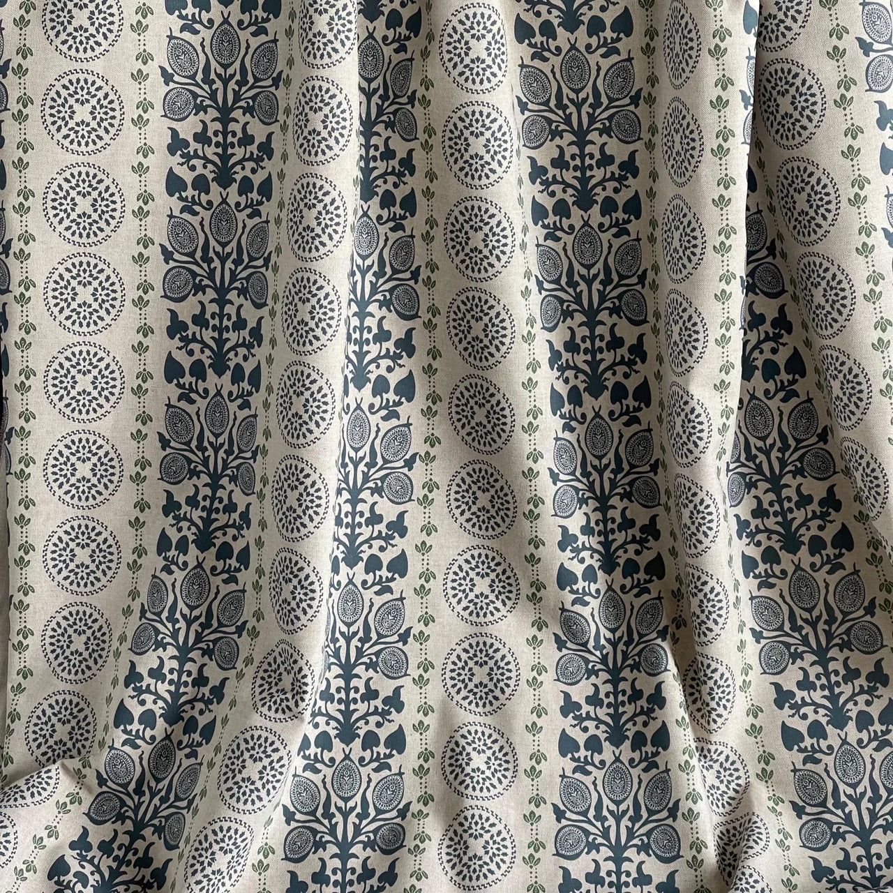 Navy upholstery fabric with symmetrical botanical medallions and vertical layout