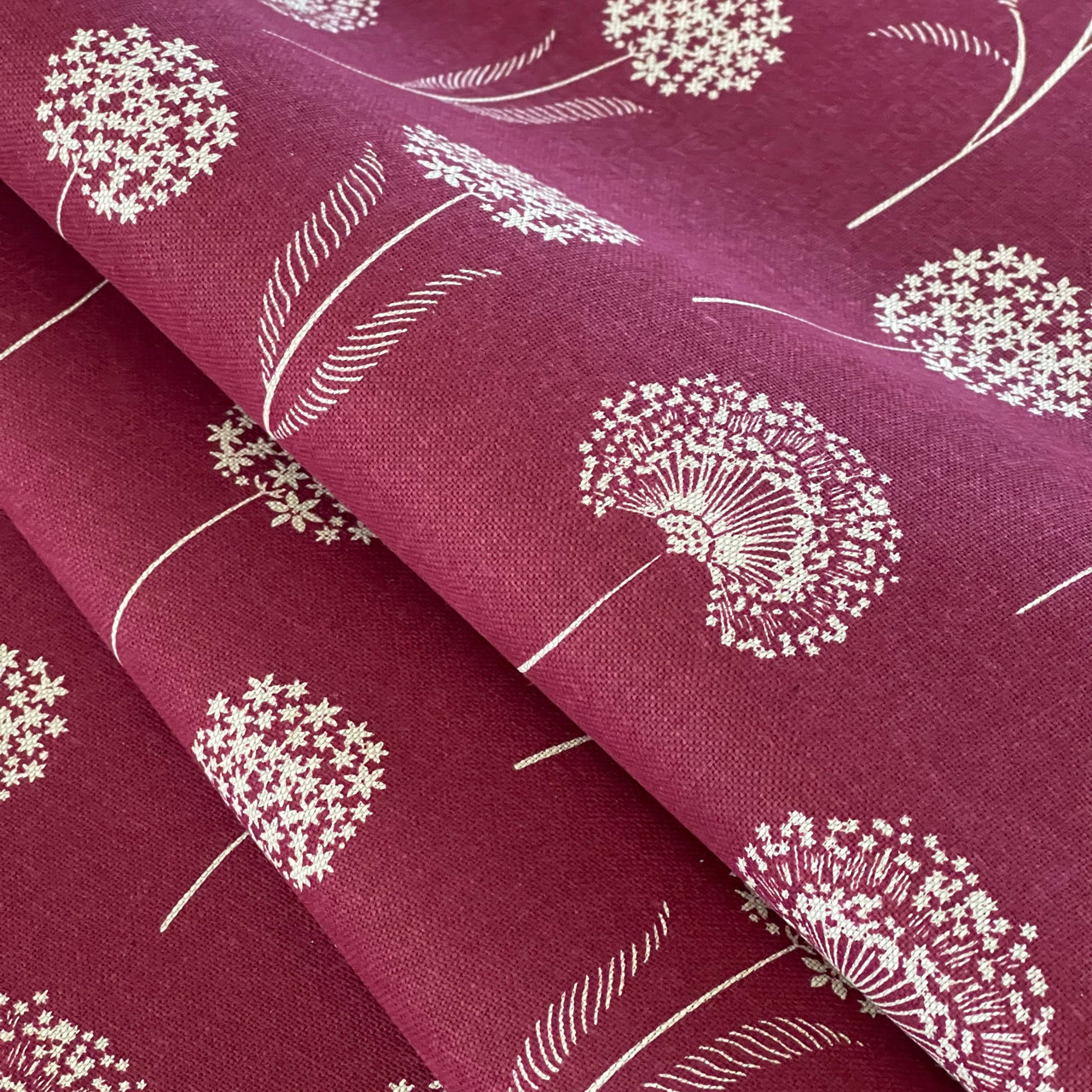 Red and white dandelion fabric styled in warm wood setting