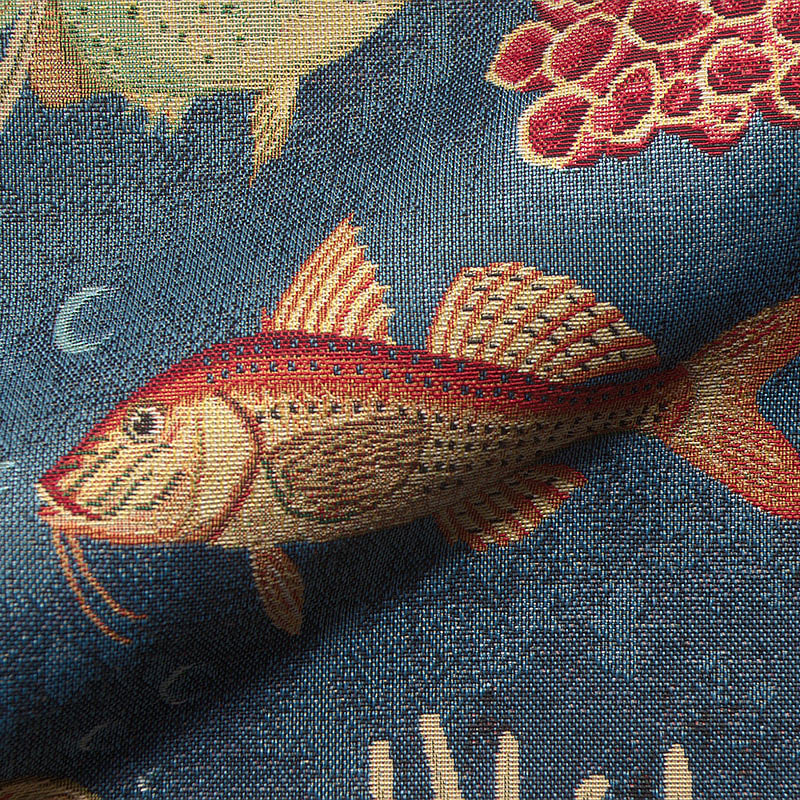 Blue upholstery fabric with fish and coral pattern.
