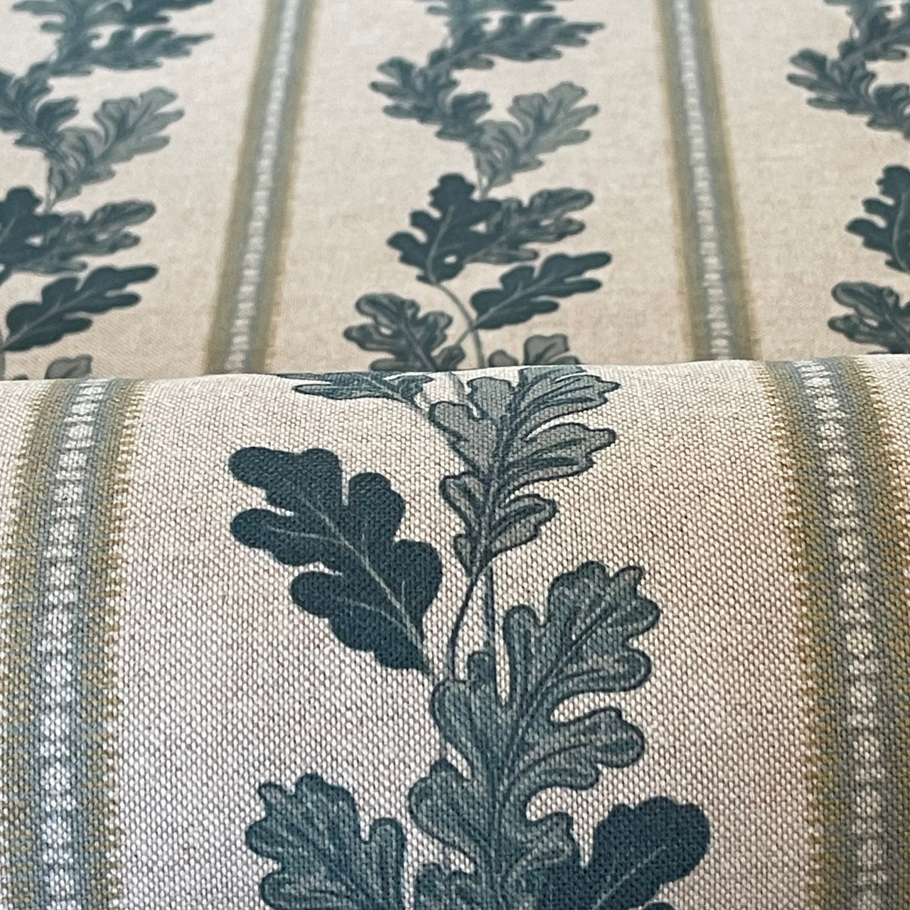 Rustic oak leaf and stripe pattern on deep olive green fabric