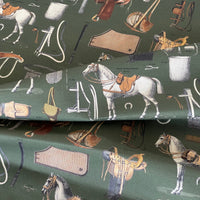 Thumbnail for Fabric with equestrian-themed pattern featuring horses, saddles, and other tack on a green background.