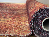Thumbnail for Roll of patterned fabric with a textured edge on a wooden surface