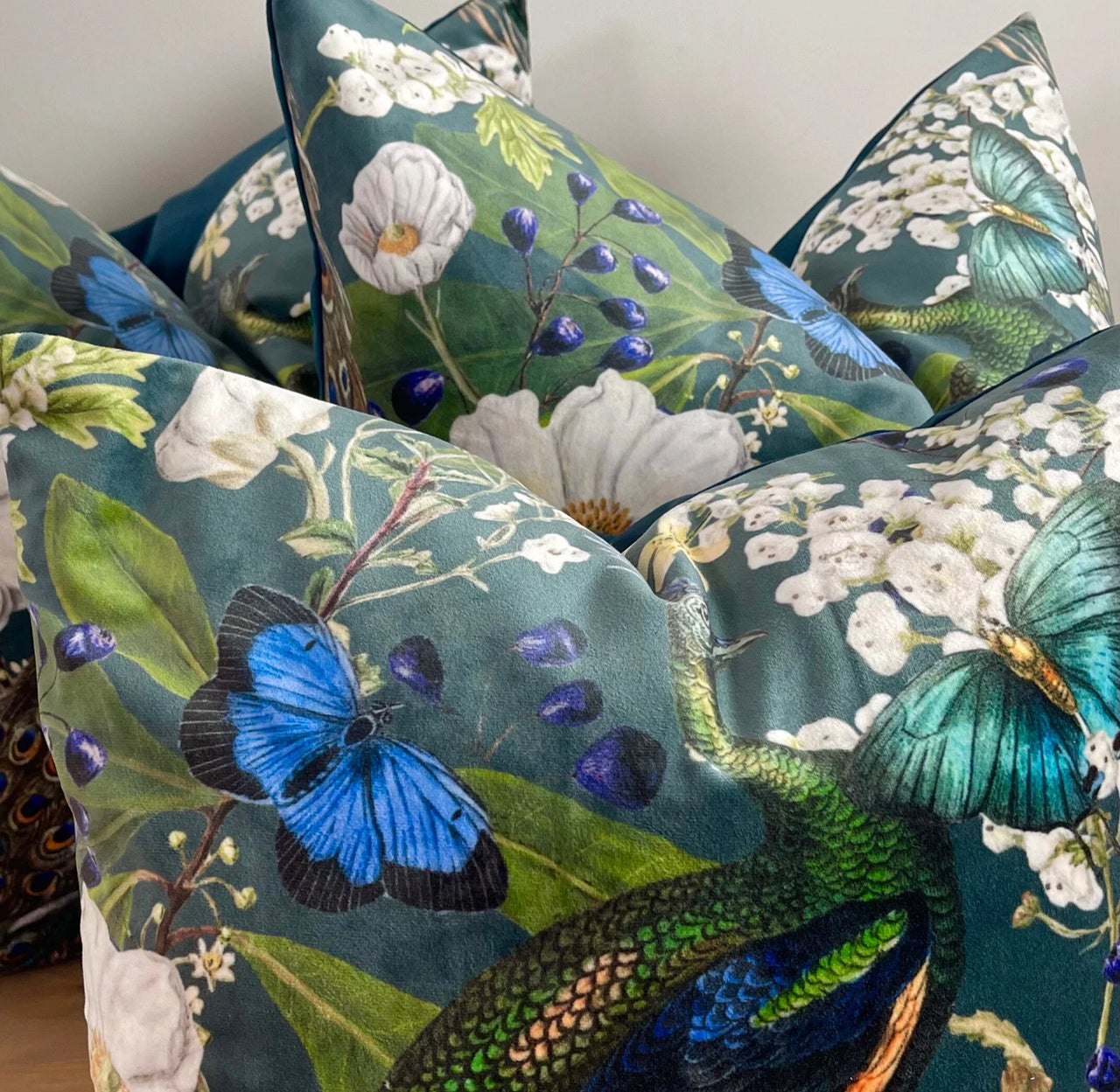 Green cushion with exotic bird and plant design.

