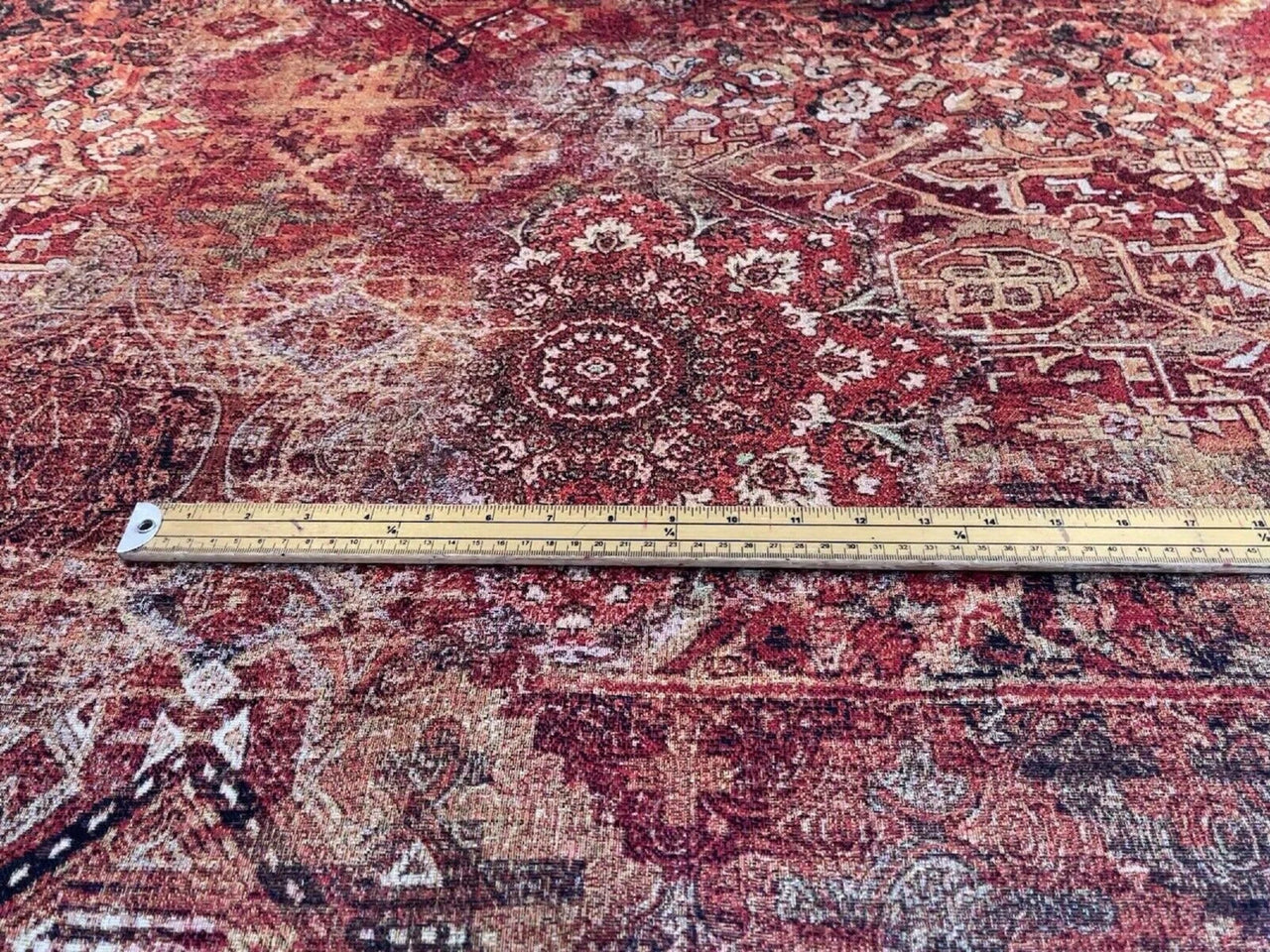 Detailed view of kilim-inspired upholstery fabric with rich geometric and floral motifs in earthy tones