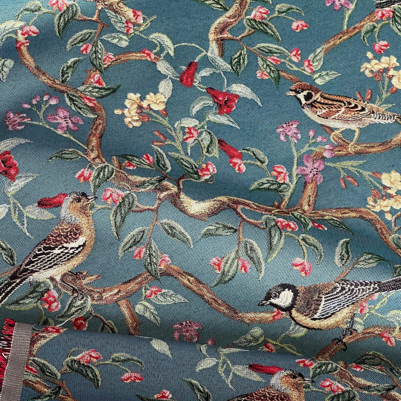 Textured upholstery textile featuring birds on leafy branches