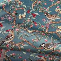 Thumbnail for Textured upholstery textile featuring birds on leafy branches