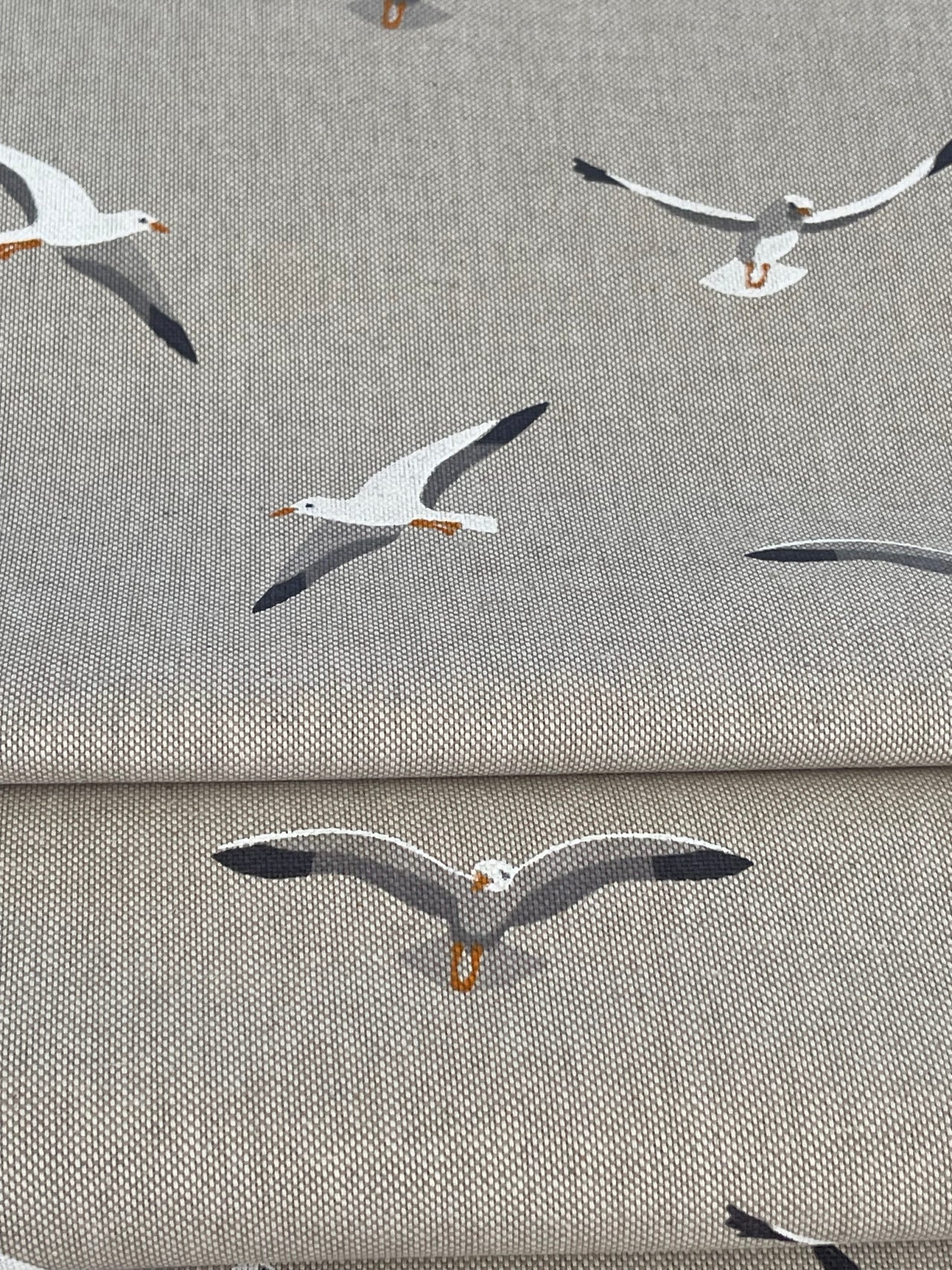Textile with seagull pattern on a gray background