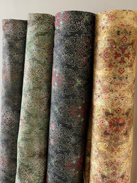 Thumbnail for Five rolls of patterned fabric in different colors on a white background
