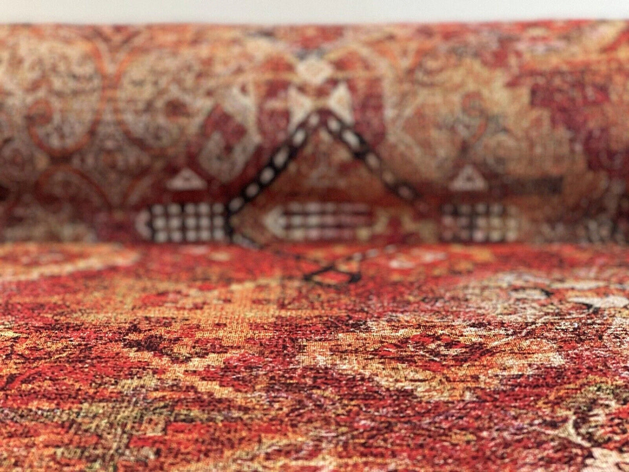 Close-up of a patterned fabric with red and brown colors
