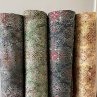 Thumbnail for Four rolls of patterned fabric with different designs on a neutral background