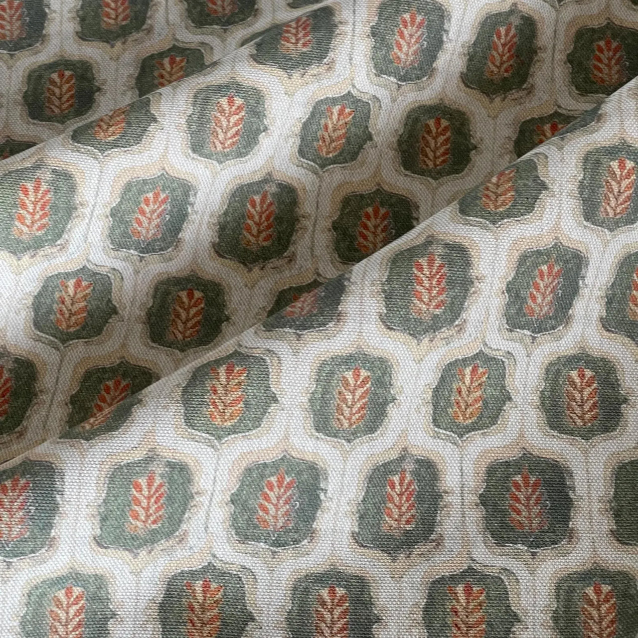 Cotton linen look fabric with olive trellis and rust botanical motif.