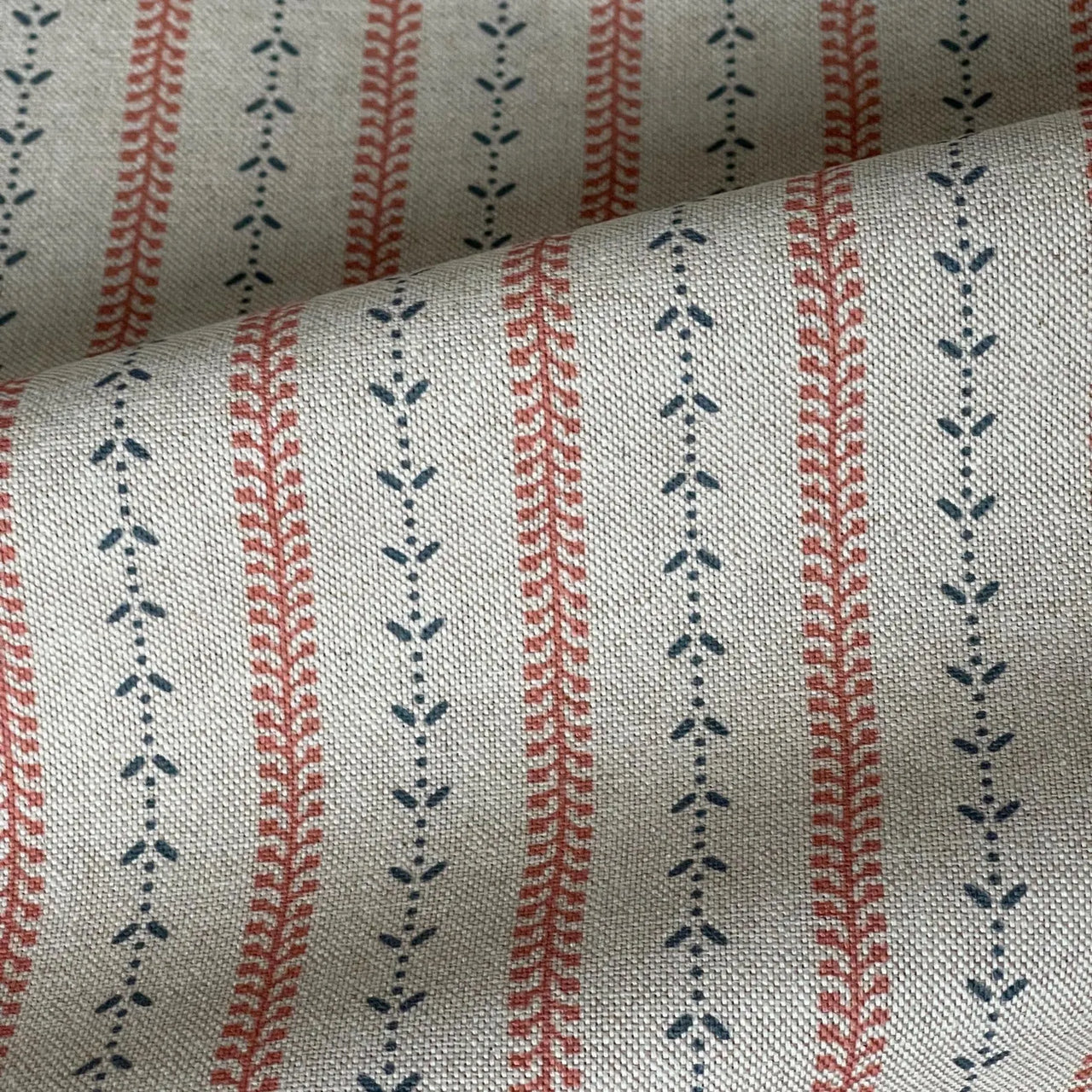 Indigo and red botanical stripe fabric on natural linen-look cotton