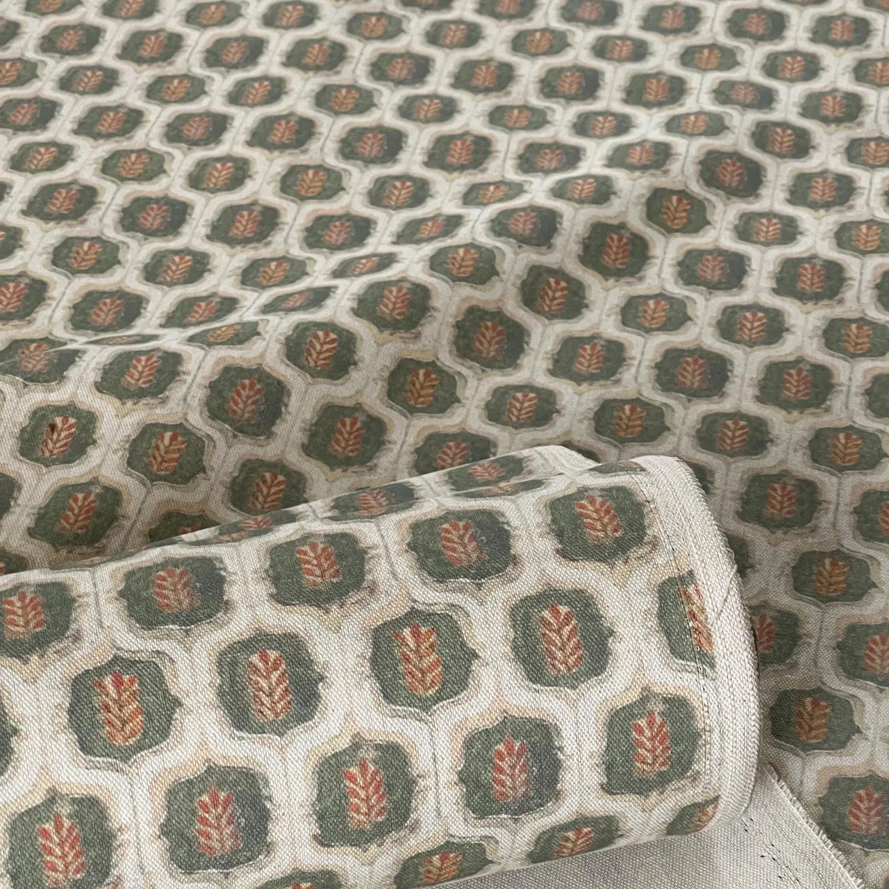 Fabric rolls featuring olive rust leaf trellis design.