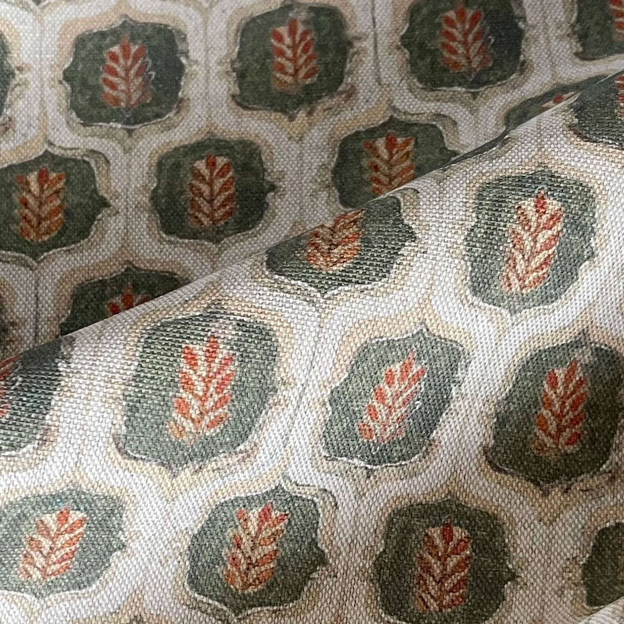Olive rust leaf trellis fabric close-up in cotton linen texture.