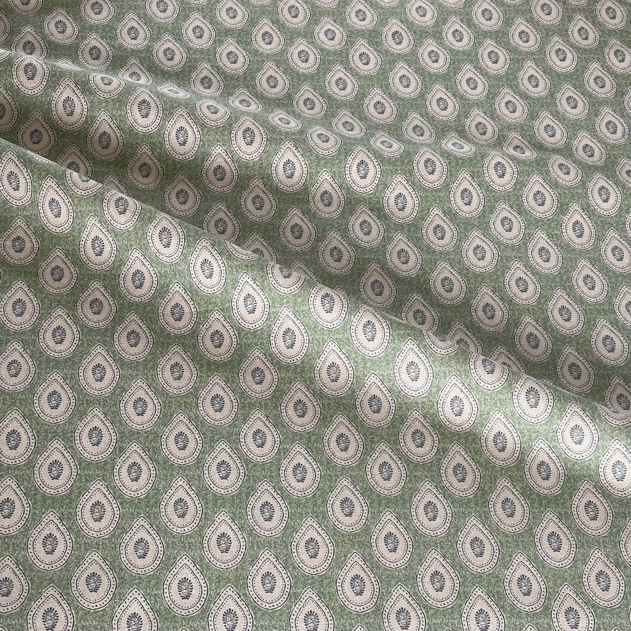 Green paisley fabric styled for modern boho interiors