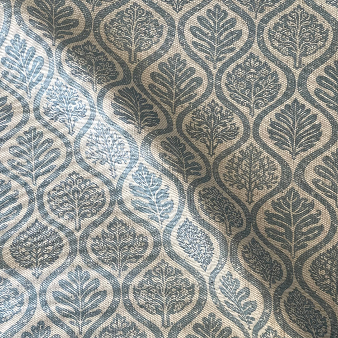 Denim blue upholstery fabric with Nordic inspired leaf motifs