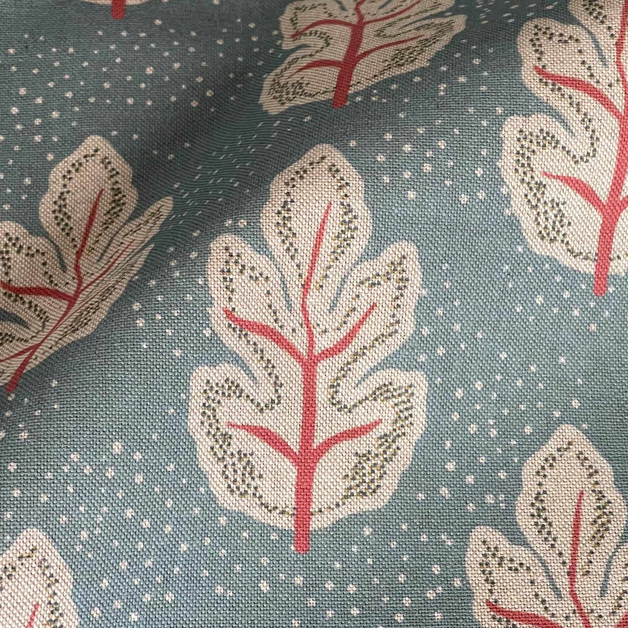 Teal leaf print fabric with cream botanical design and red vein detail