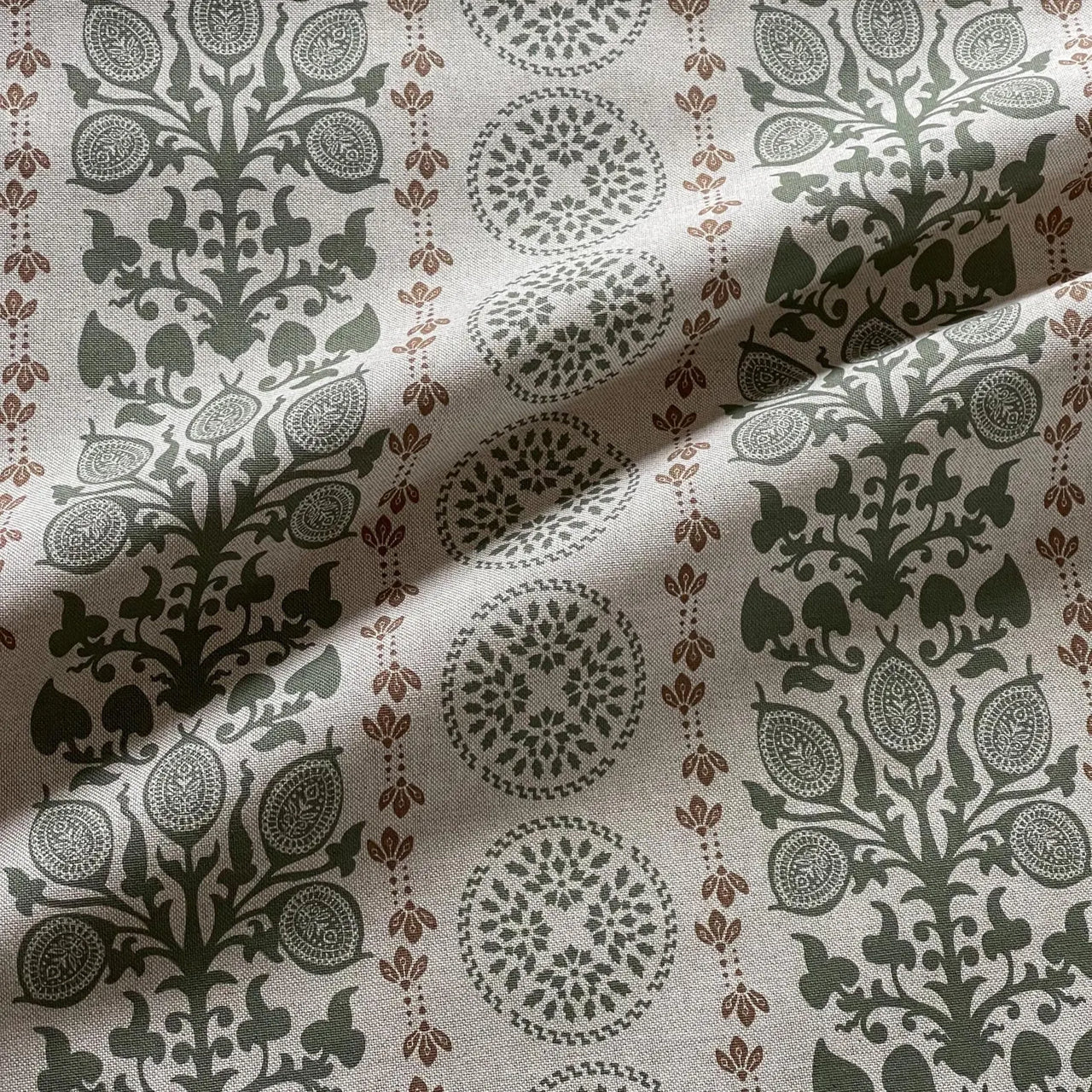 Upholstery fabric with botanical medallion print in green and warm rust tones