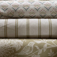 Thumbnail for Three rolls of fabric with different patterns stacked on top of each other.