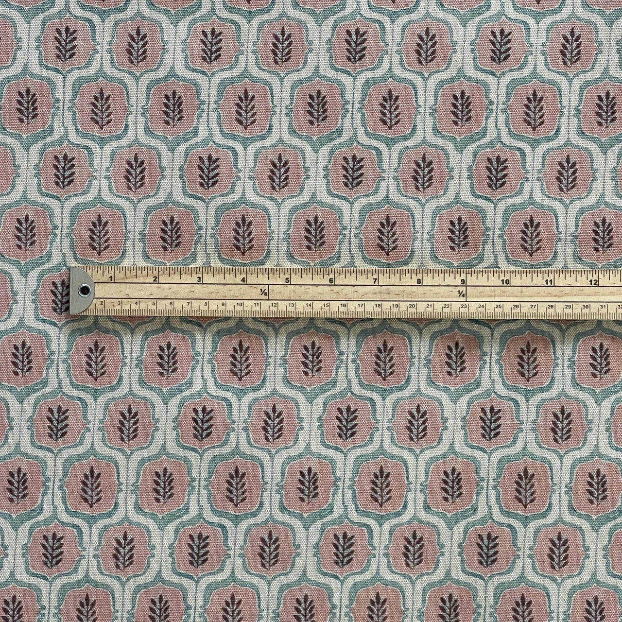 Blush trellis curtain fabric with natural woven texture.