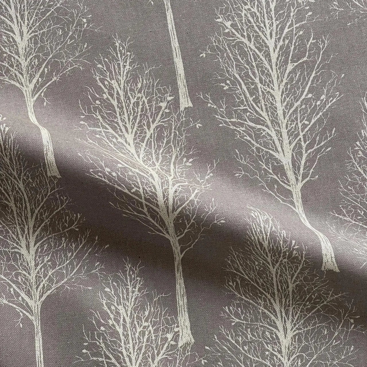 Grey tree silhouette upholstery fabric with linen texture