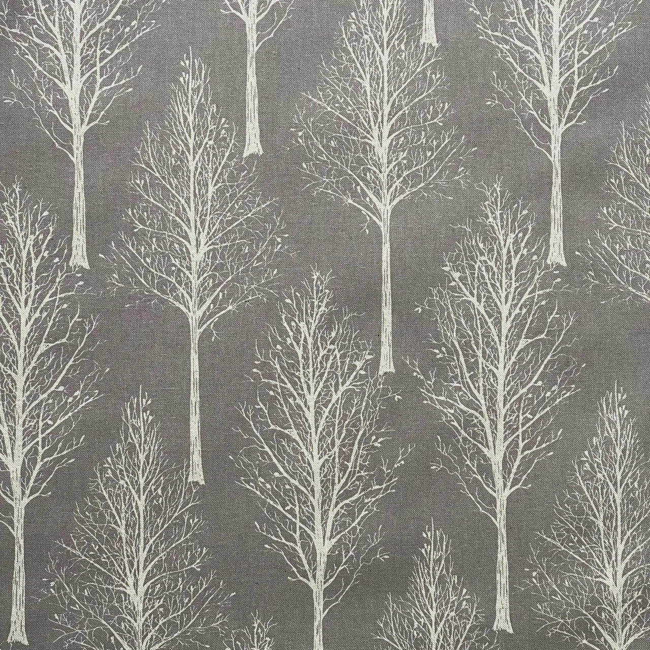 Grey cotton blend fabric featuring delicate tree branches