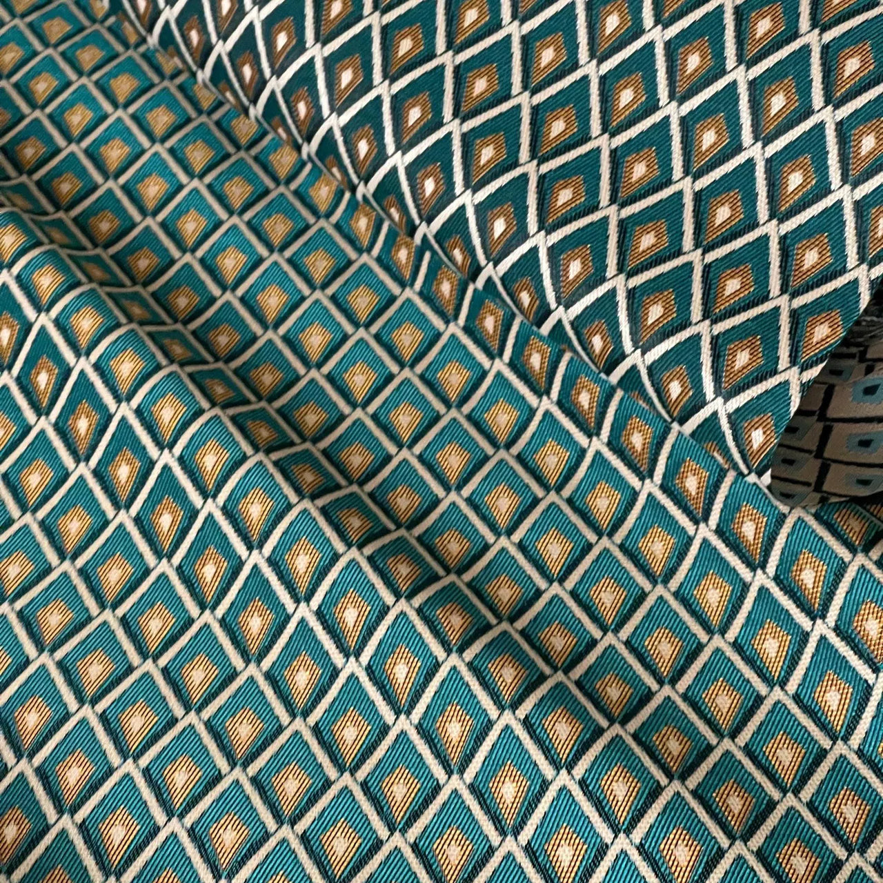 Jacquard woven teal and gold fabric sold by the metre