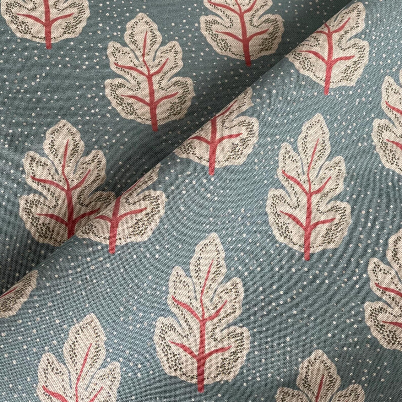 Modern Scandinavian leaf fabric with subtle dotted background