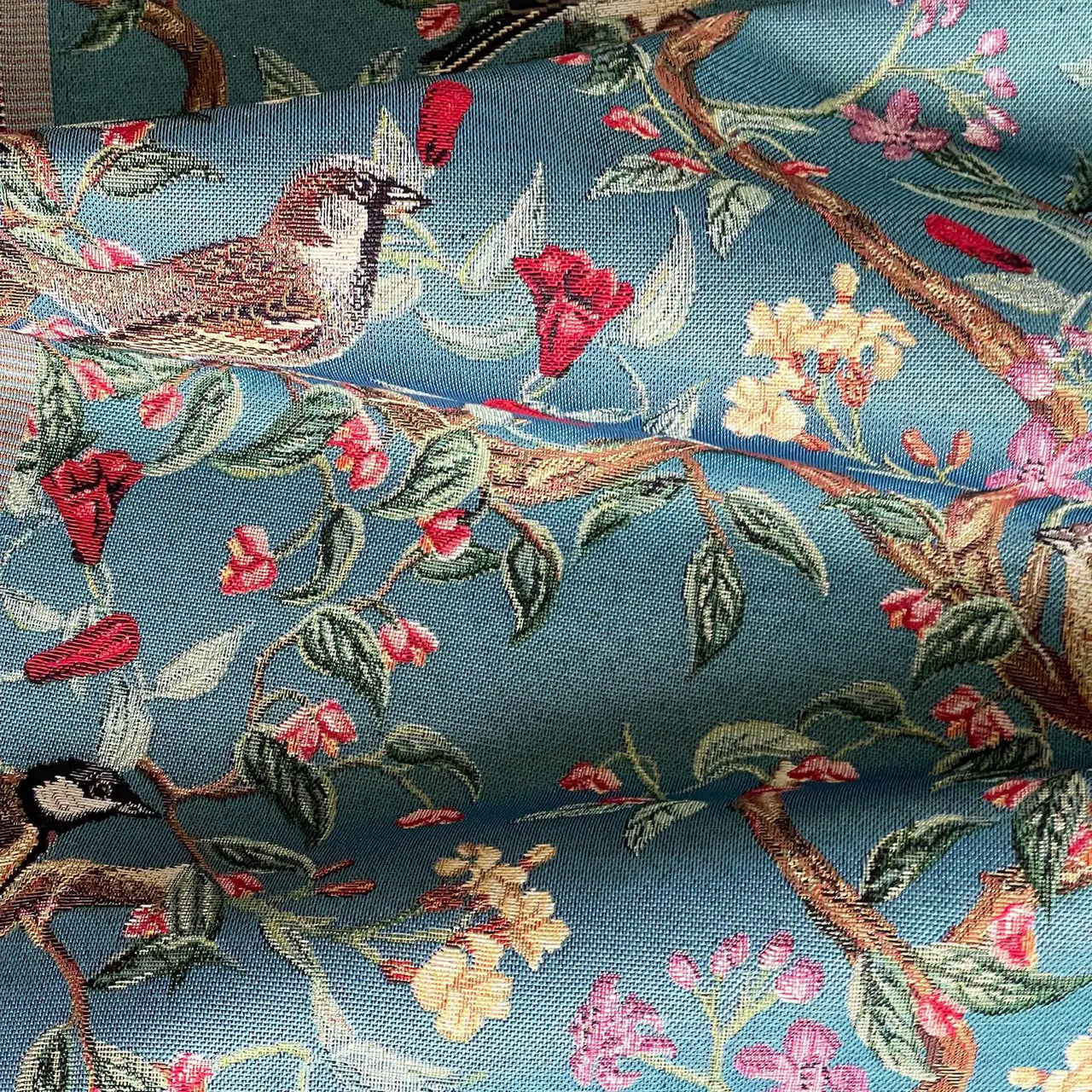 Decorative upholstery fabric with woven bird and blossom pattern