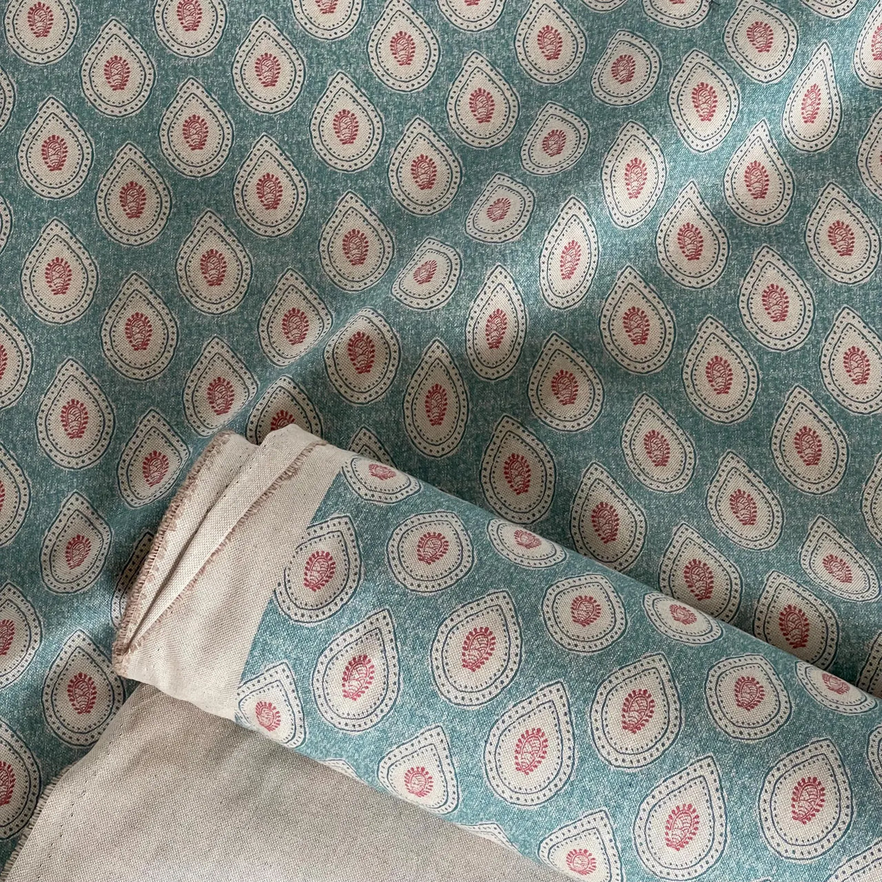 Boho paisley fabric in teal with ivory motifs and red accents