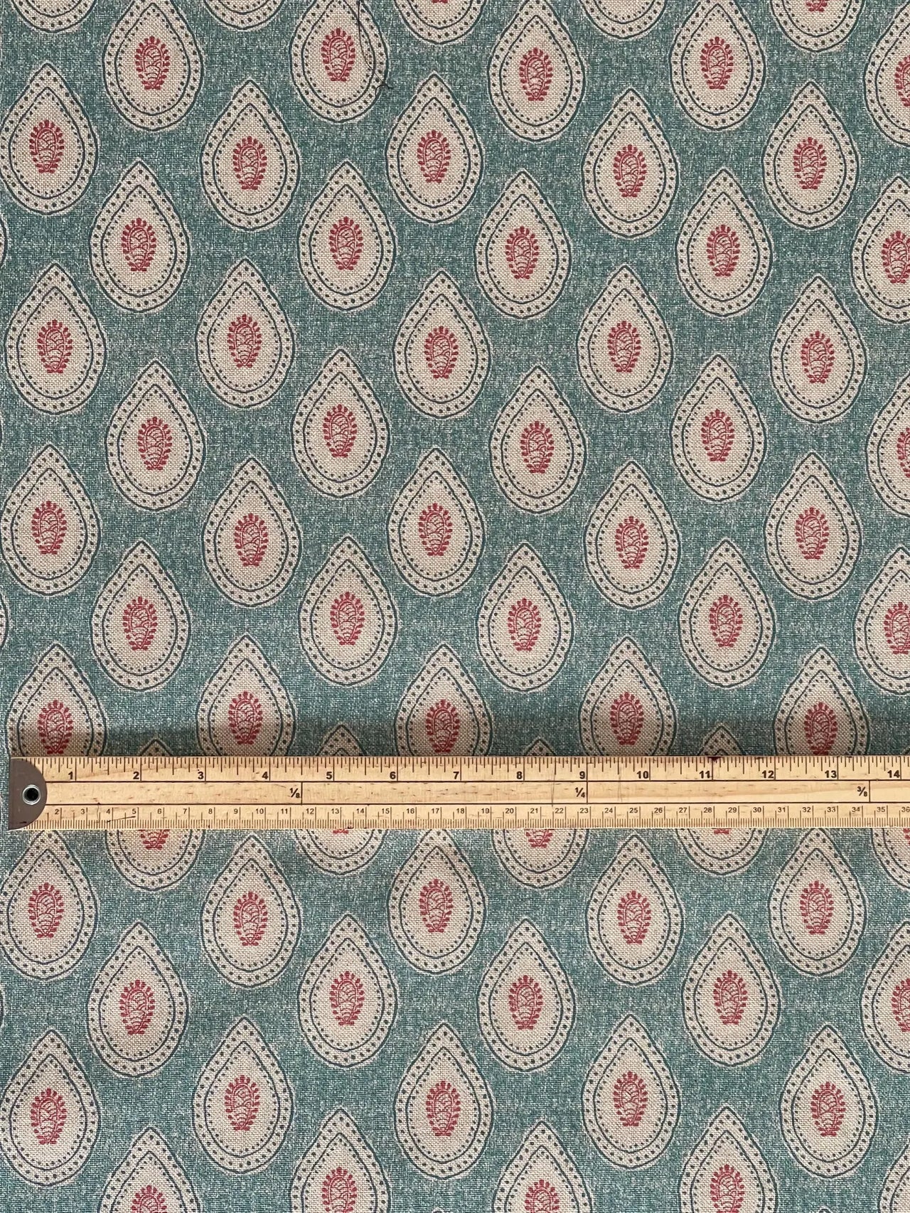 Teal decorative fabric with repeating paisley motif design