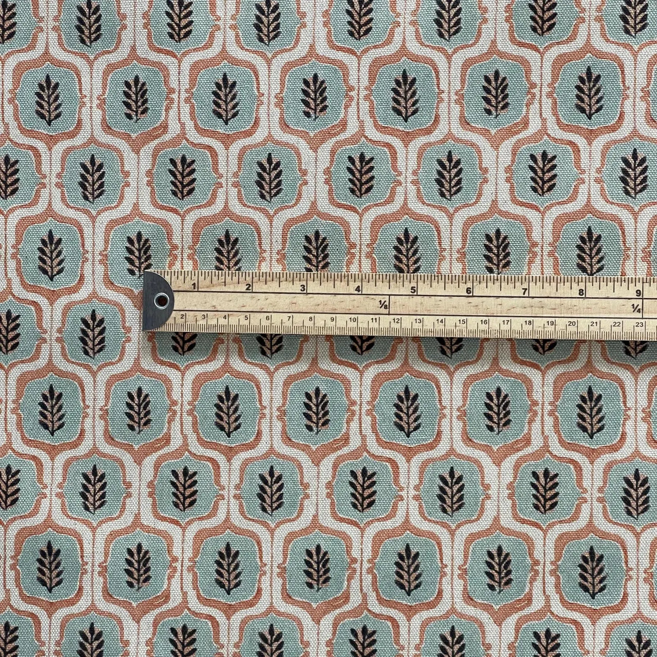 Fabric with a geometric leaf pattern and a ruler for scale