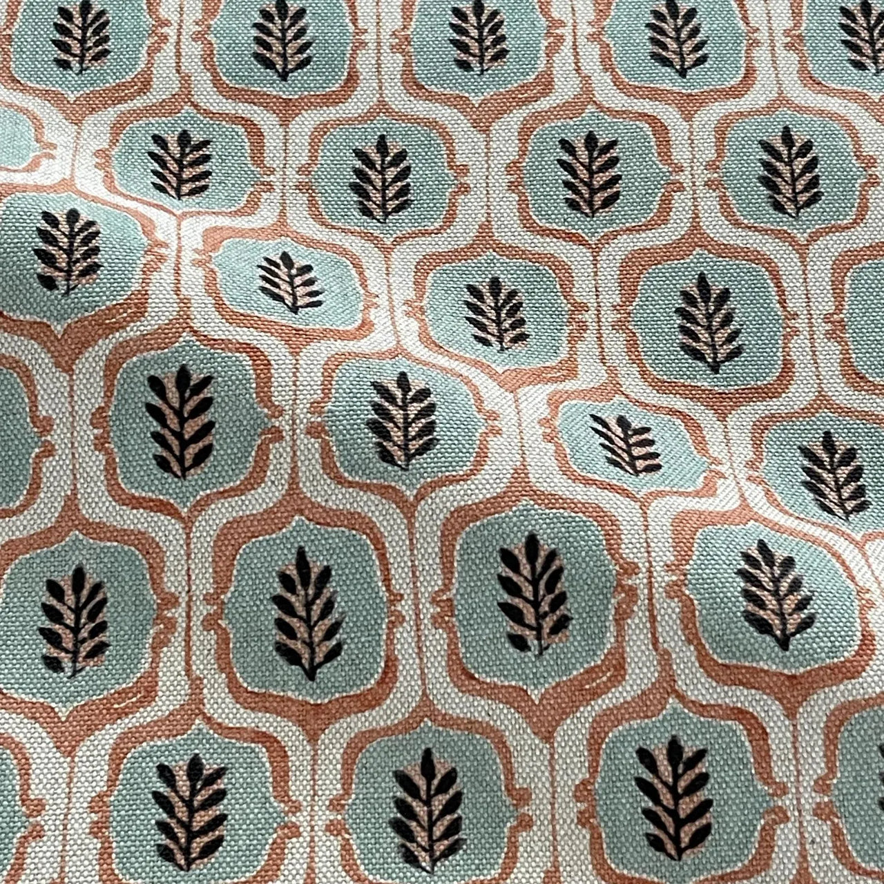 Sage rust leaf trellis fabric close-up in cotton linen texture.