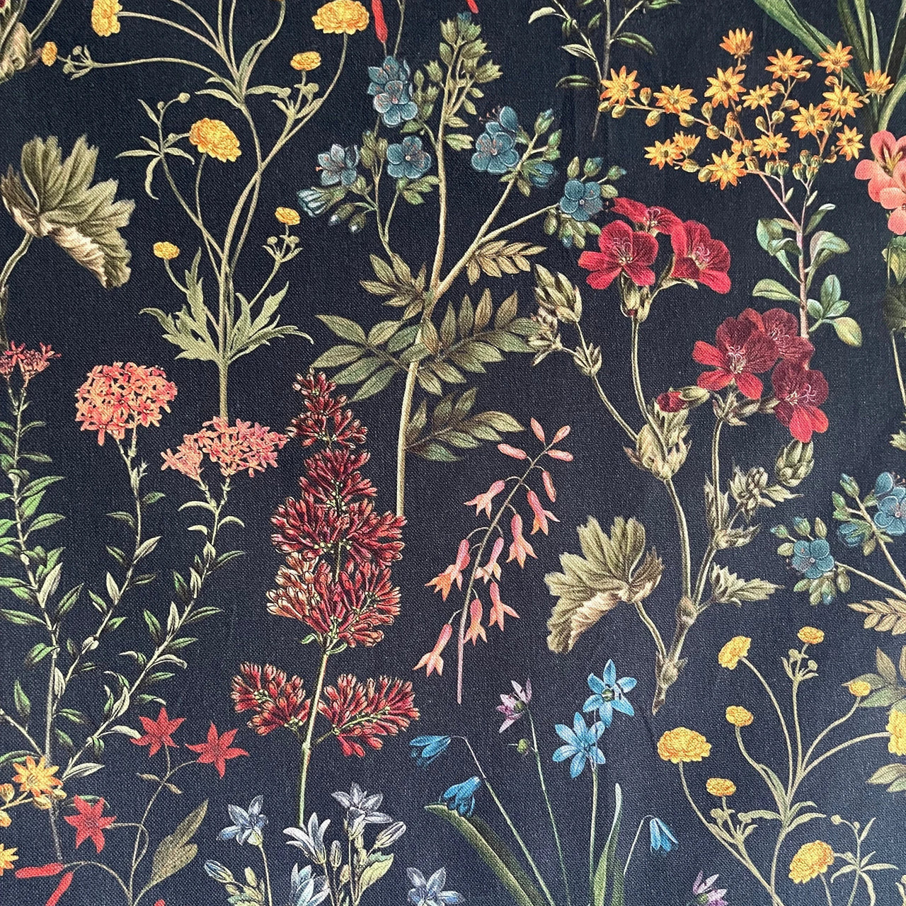 Floral pattern with red, blue, and yellow flowers on a dark background