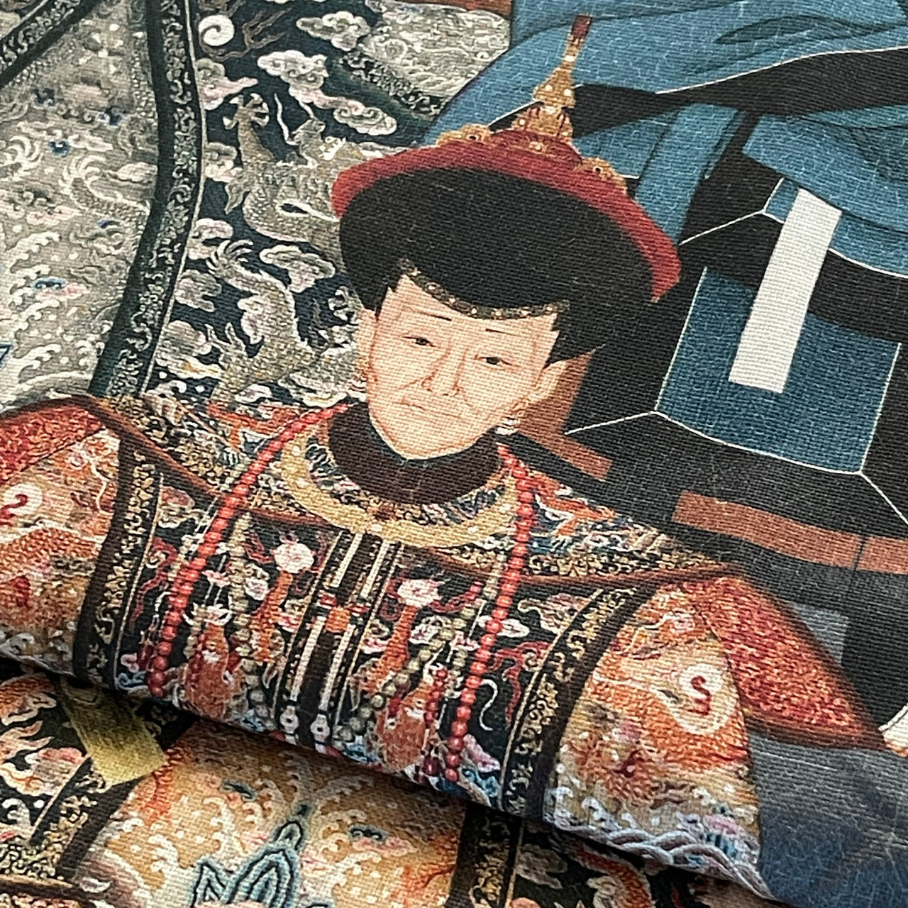 Close-up of "The Emperors" organic cotton fabric with Chinese imperial portraits in full regalia